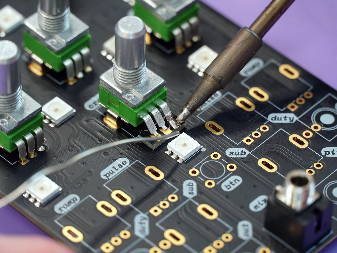 Custom electronic system development and PCB inspection in Emerald Control workshop